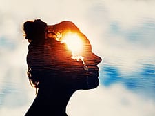 silhouette of woman's head against the sky