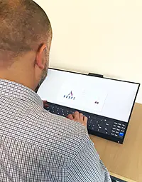 A person logging into ADAPT on a touch screen