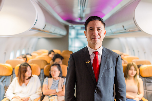 A flight attendant smiling