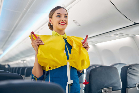 Flight attendant demonstrating a life jacket