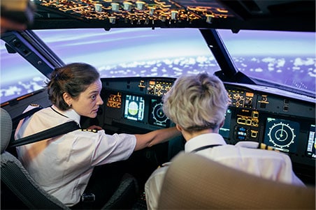 A pilot instructing in a cockpit