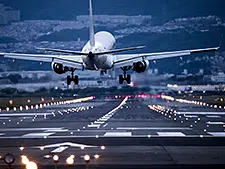 A commercial jet landing at night