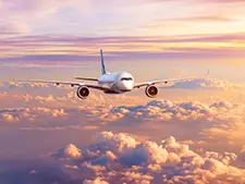 A passenger jet flying above the clouds