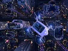 An eVTOL flying over a city at night