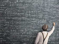A man writing on a blackboard