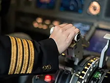 A pilot of a plane holding the controls